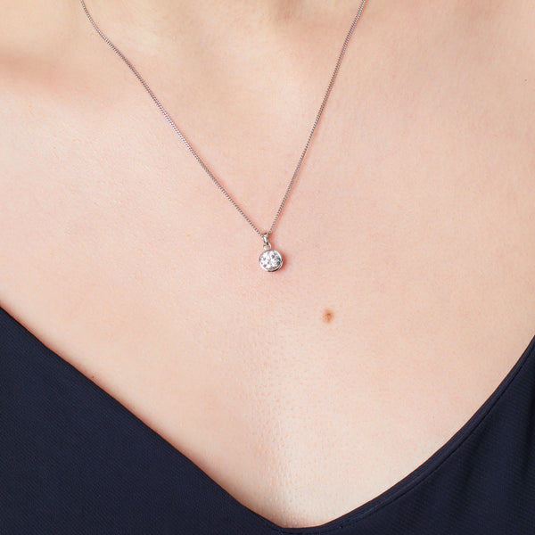 Solid 925 sterling silver round solitaire pendant with a brilliant-cut cubic zirconia in a bezel setting on a silver curb chain.