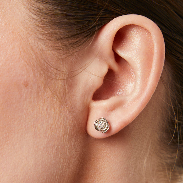 A pair of sterling silver rose flower stud earrings with a single zirconia centre stone each-JOOLS by Jenny Brown
