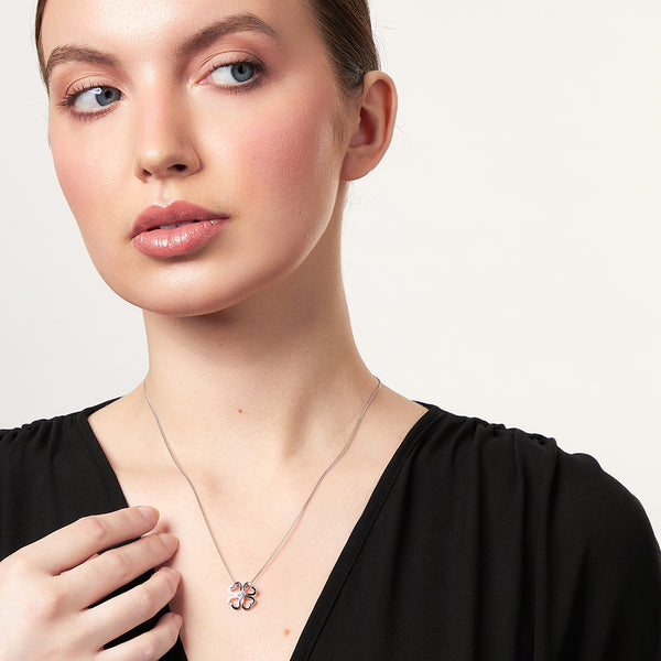 Sterling silver open four leaf clover pendant with a 3mm central cubic zirconia, attached to a silver chain-JOOLS by Jenny Brown