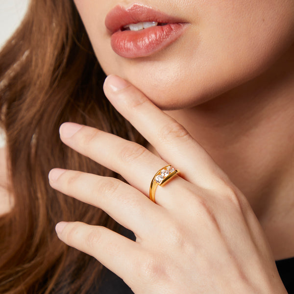 Gold ring featuring three sparkling diamonds set between two sleek, curved bands-JOOLS by Jenny Brown