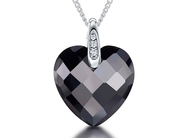A sterling silver necklace with a black faceted heart-shaped pendant on a chain.