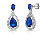 Load image into Gallery viewer, A pair of sterling silver teardrop earrings featuring deep blue sapphire cubic zirconia with a halo of smaller cubic zirconia stones around the edge.