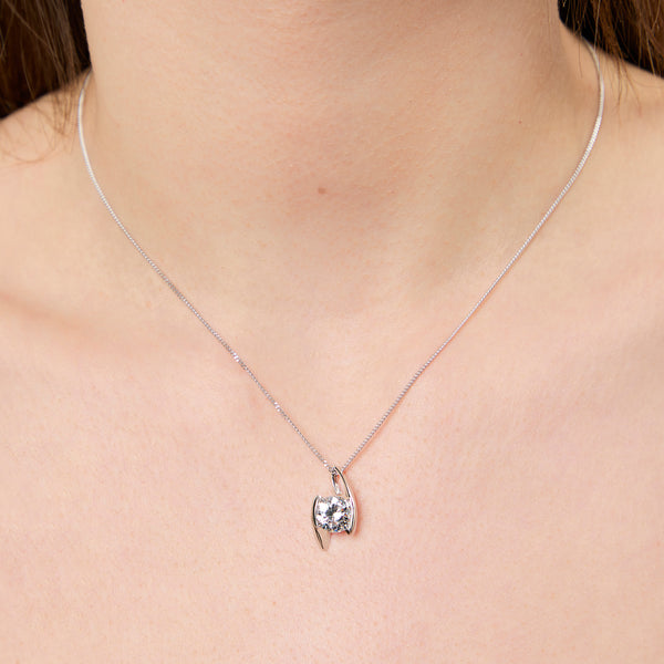 A sterling silver 2 carat solitaire pendant with a round cubic zirconia stone offset held by two silver bars, on a chain-JOOLS by Jenny Brown