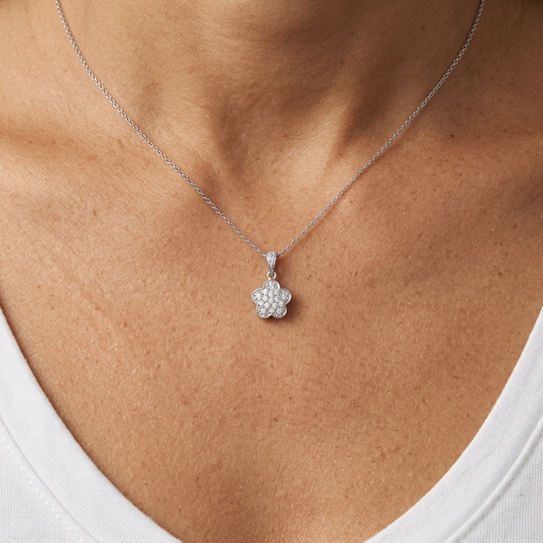 Model neck showng a sterling silver clover flower pendant necklace with pave set cubic zirconias,
