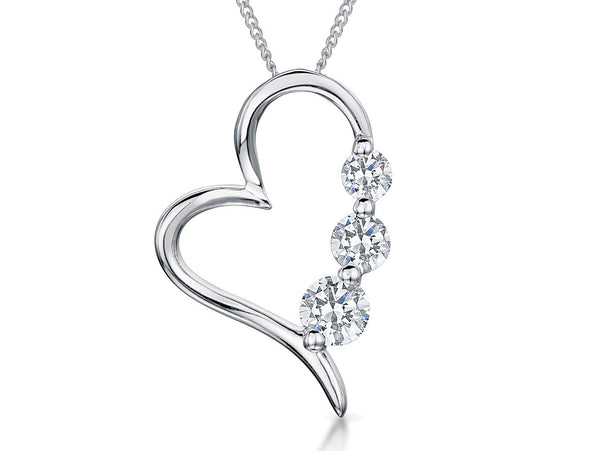 A sterling silver heart-shaped pendant with three cubic zirconia stones set within it, attached to a silver chain- JOOLS By Jenny Brown