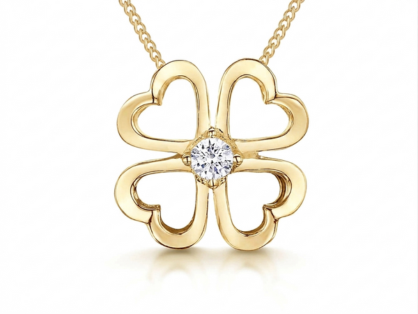 Gold four-leaf clover pendant with a diamond on a white background