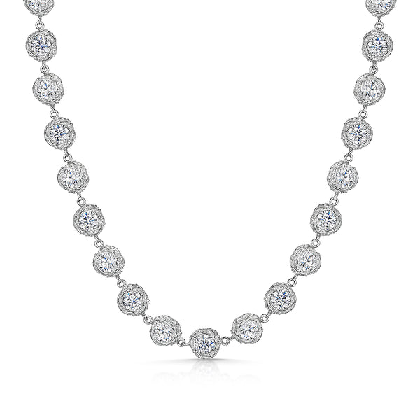 A sterling silver necklace with a twisted chain design and round cubic zirconia stones set in a pave setting.
