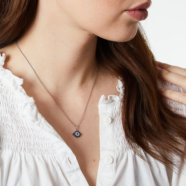 A sterling silver necklace featuring a blue and white cubic zirconia evil eye pendant - JOOLS By Jenny Brown