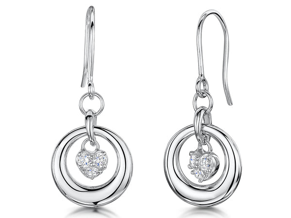 A pair of sterling silver hoop earrings with a heart-shaped cubic zirconia drop, one earring is shown from the front and the other from the back, both featuring a rhodium finish.
