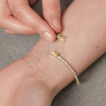 Load image into Gallery viewer, A yellow gold 2mm cubic zirconia tennis bracelet with cubic zirconia stones, featuring a snap fastening- JOOLS By Jenny Brown
