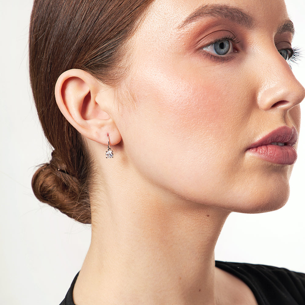 A pair of half carat sterling silver fishhook drop earrings with cubic zirconia stones.