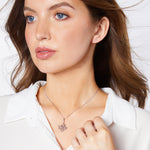 Load image into Gallery viewer, Sterling silver pendant with a graduated multi-flower design set with cubic zirconia centres, on a chain.-JOOLS by Jenny Brown
