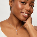 Load image into Gallery viewer, A sterling silver drop bubble pendant with four set cubic zirconia stones, suspended from a chain-JOOLS by Jenny Brown
