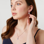 Load image into Gallery viewer, A pair of sterling silver pear drop halo earrings with cubic zirconia centers-JOOLS by Jenny Brown
