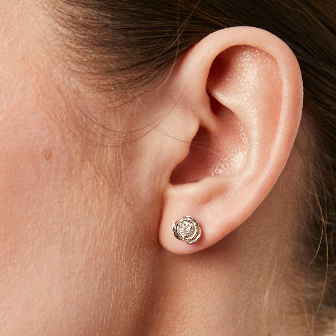 A pair of sterling silver rose flower stud earrings with a single zirconia centre stone each-JOOLS by Jenny Brown