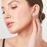 Load image into Gallery viewer, A pair of sterling silver triangle stud earrings with cubic zirconia, rhodium finished, with post and butterfly backing-JOOLS by Jenny Brown
