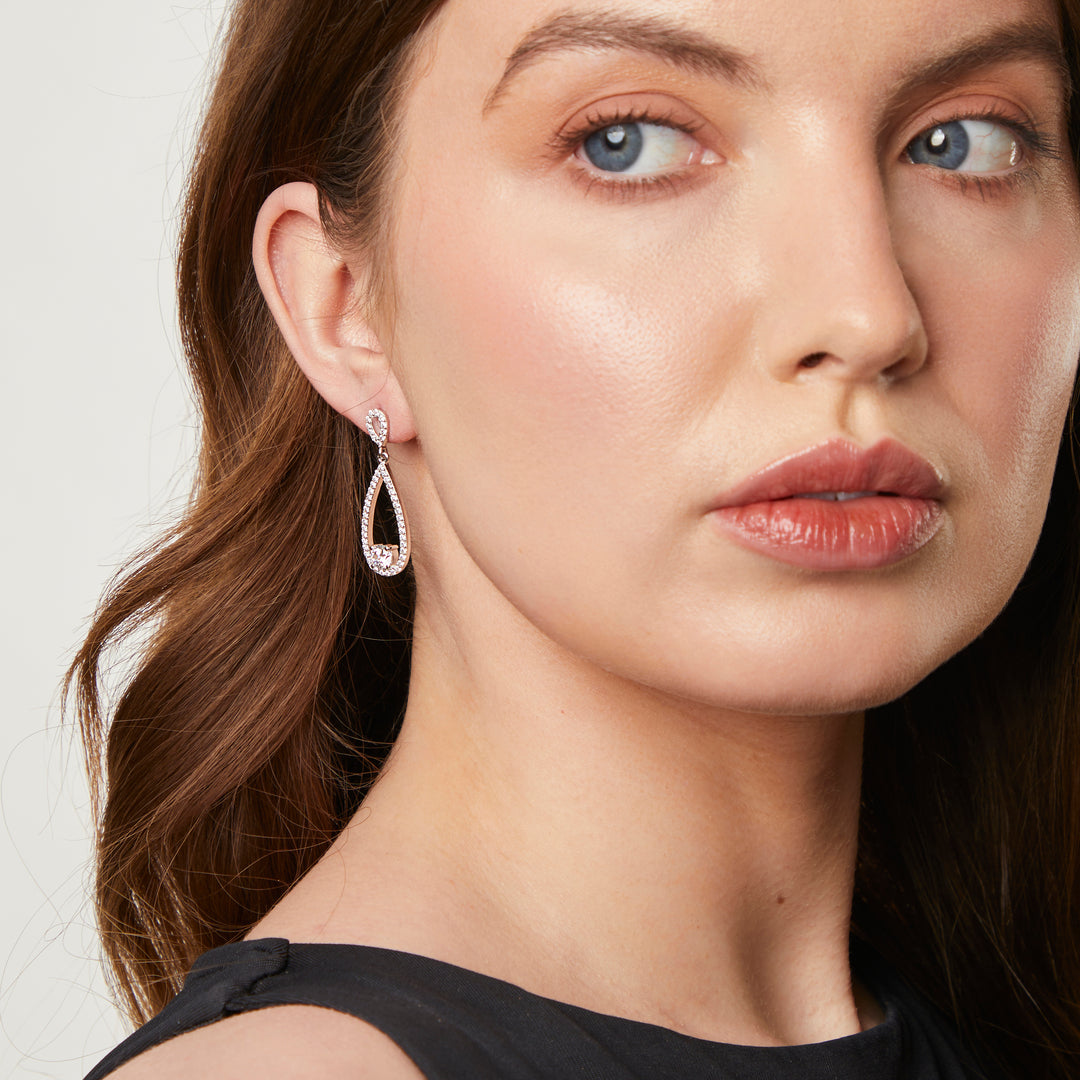 A pair of sterling silver teardrop earrings with a single cubic zirconia stone in the center, surrounded by smaller pave-set cubic zirconia stones.-JOOLS by Jenny Brown