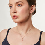 Load image into Gallery viewer, A sterling silver pendant with three cubic zirconia stones arranged in a curved drop design-JOOLS by Jenny Brown
