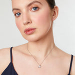 Load image into Gallery viewer, Sterling silver pendant in the shape of a butterfly wing, featuring a central cubic zirconia round cut stone with smaller stones along the edges,JOOLS by Jenny Brown
