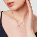 Load image into Gallery viewer, Sterling silver pendant in the shape of a butterfly wing, featuring a central cubic zirconia round cut stone with smaller stones along the edges,JOOLS by Jenny Brown
