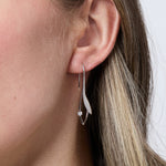 Load image into Gallery viewer, Close-up of a woman's ear  wearingSterling Silver Leaf Drop Earrings - JOOLS By Jenny Browne.
