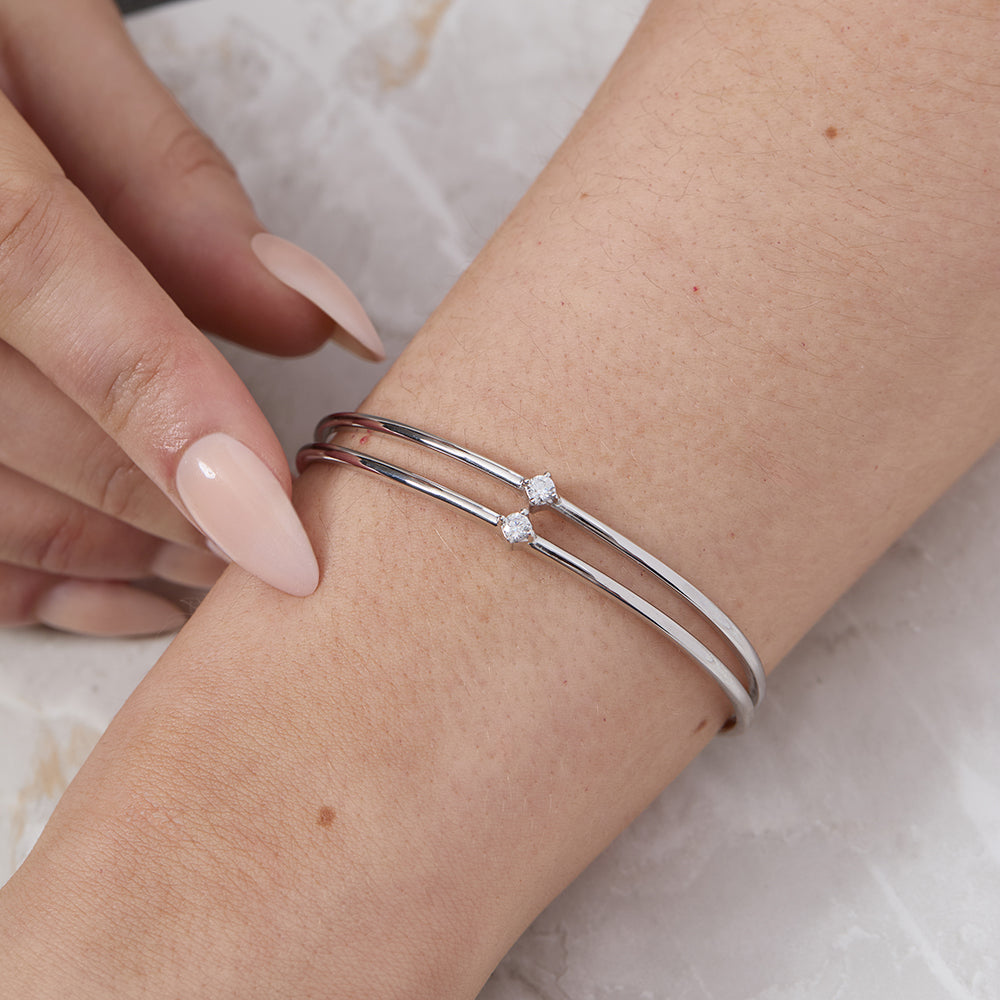 Model wrist showing  sterling silver bangle bracelet with a two-row solid pattern set with cubic zirconia stones-JOOLS by Jenny Brown