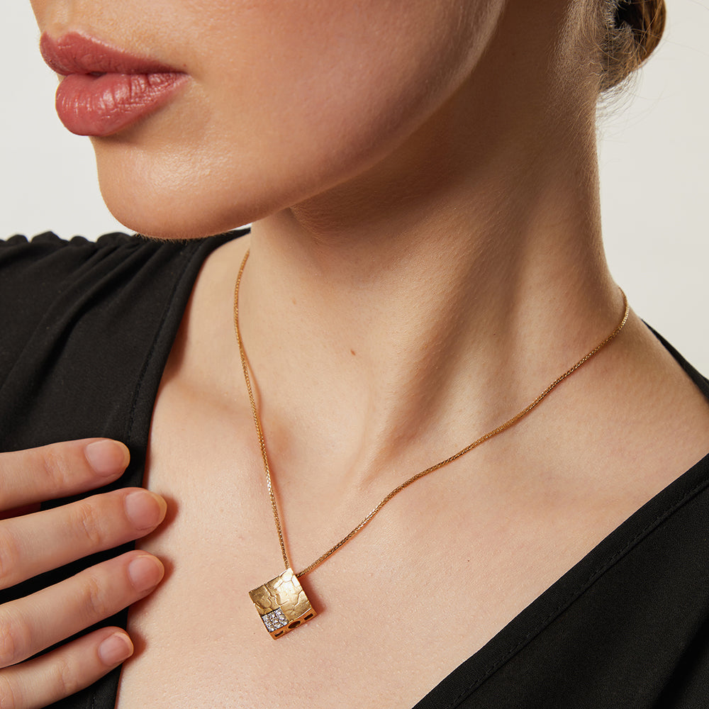 A yellow gold diamond offset textured square pendant on a 16-inch box chain.