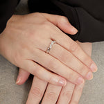 Load image into Gallery viewer, An 18 carat white gold ring with a zig zag diamond pattern and a wave band design, containing seven round cut diamonds.
