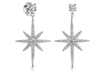 Load image into Gallery viewer, A pair of sterling silver north star drop stud earrings with a geometric star pattern and cubic zirconia stones, -JOOLS by Jenny Brown
