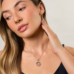 Load image into Gallery viewer, A sterling silver pendant with three silver rings and a suspended cubic zirconia center stone.-JOOLS by Jenny Brown
