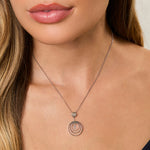 Load image into Gallery viewer, A sterling silver pendant with three silver rings and a suspended cubic zirconia center stone.-JOOLS by Jenny Brown
