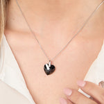 Load image into Gallery viewer, A sterling silver necklace with a black faceted heart-shaped pendant on a chain.
