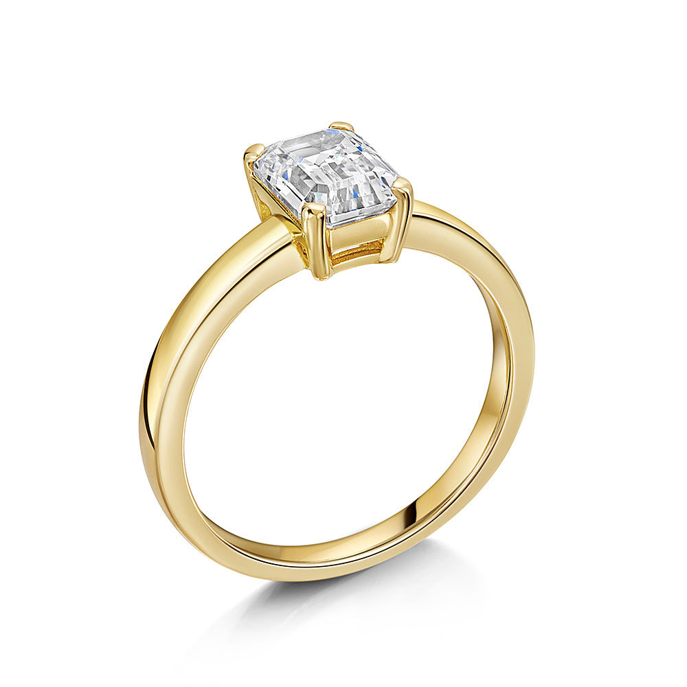 18K gold vermeil over 925 sterling silver solitaire ring with an emerald-cut white cubic zirconia in a four-prong setting.