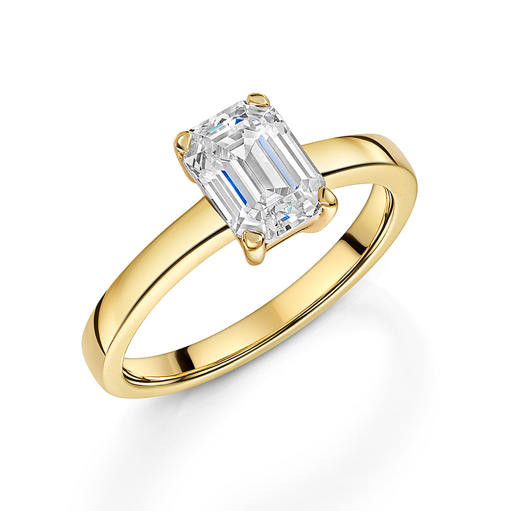 18K gold vermeil over 925 sterling silver solitaire ring with an emerald-cut white cubic zirconia in a four-prong setting.