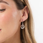 Load image into Gallery viewer, A pair of sterling silver circle drop earrings with rubover cubic zirconias.-JOOLS by Jenny Brown
