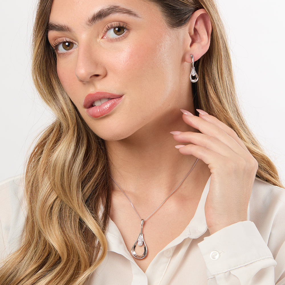 A pair of sterling silver open peardrop earrings with inner lines of cubic zirconia, featuring a hypoallergenic rhodium finish.