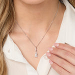 Load image into Gallery viewer, Sterling Silver Pendant with a radiant cut cubic zirconia centerpiece, surrounded by smaller round CZs, attached to a sterling silver long bale and a chain.- JOOLS by Jenny Brown
