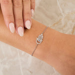 Load image into Gallery viewer, A sterling silver bracelet with a hamsa hand charm, set with cubic zirconia and a deep blue sapphire zirconia -JOOLS by Jenny Brown

