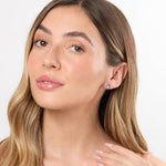 Load image into Gallery viewer, A pair of sterling silver stud earrings with a ribbon design featuring white cubic zirconia center stones-JOOLS by Jenny Brown
