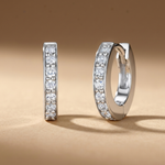Load image into Gallery viewer, Solid 925 sterling silver huggie hoop earrings with white AAA+ cubic zirconia pavé stones and a hinged click-closure.
