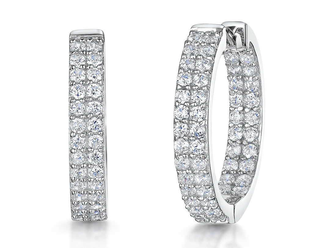 A pair of sterling silver hoop earrings with a double row of cubic zirconia stones.-JOOLS by Jenny Brown