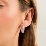 Load image into Gallery viewer, A pair of sterling silver hoop earrings with a double row of cubic zirconia stones.-JOOLS by Jenny Brown
