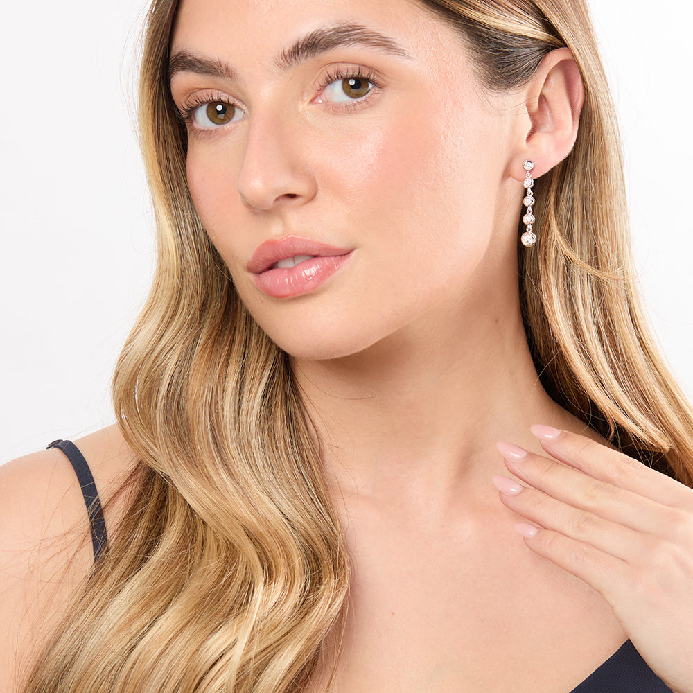 A pair of sterling silver drop earrings featuring five cubic zirconia stones, with a rhodium finish for tarnish resistance-JOOLS by Jenny Brown