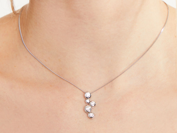 A sterling silver pendant featuring five cubic zirconia stones in a graduated bubble design, attached to a silver chain-JOOLS by Jenny Brown