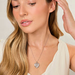 Load image into Gallery viewer, A sterling silver heart-shaped pendant covered in sparkling white cubic zirconia stones.-JOOLS by Jenny Brown
