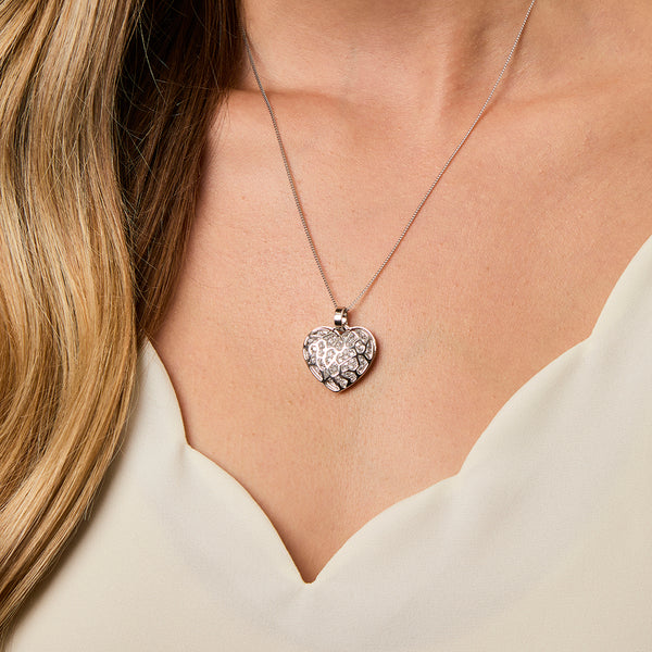 A sterling silver heart-shaped pendant covered in sparkling white cubic zirconia stones.-JOOLS by Jenny Brown