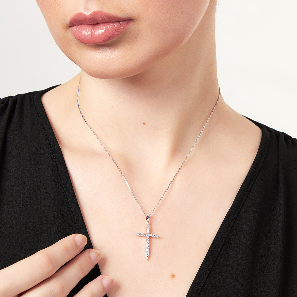 A sterling silver cross pendant encrusted with round white zirconia stones on a chain-JOOLS by Jenny Brown