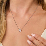 Load image into Gallery viewer, A sterling silver pave set heart-shaped pendant with cubic zirconia stones, attached to a chain-JOOLS by Jenny Brown
