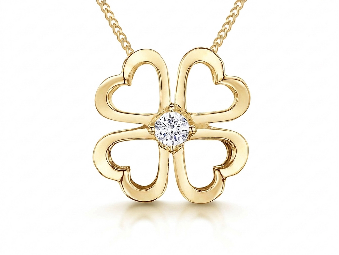 Gold four-leaf clover pendant with a diamond on a white background