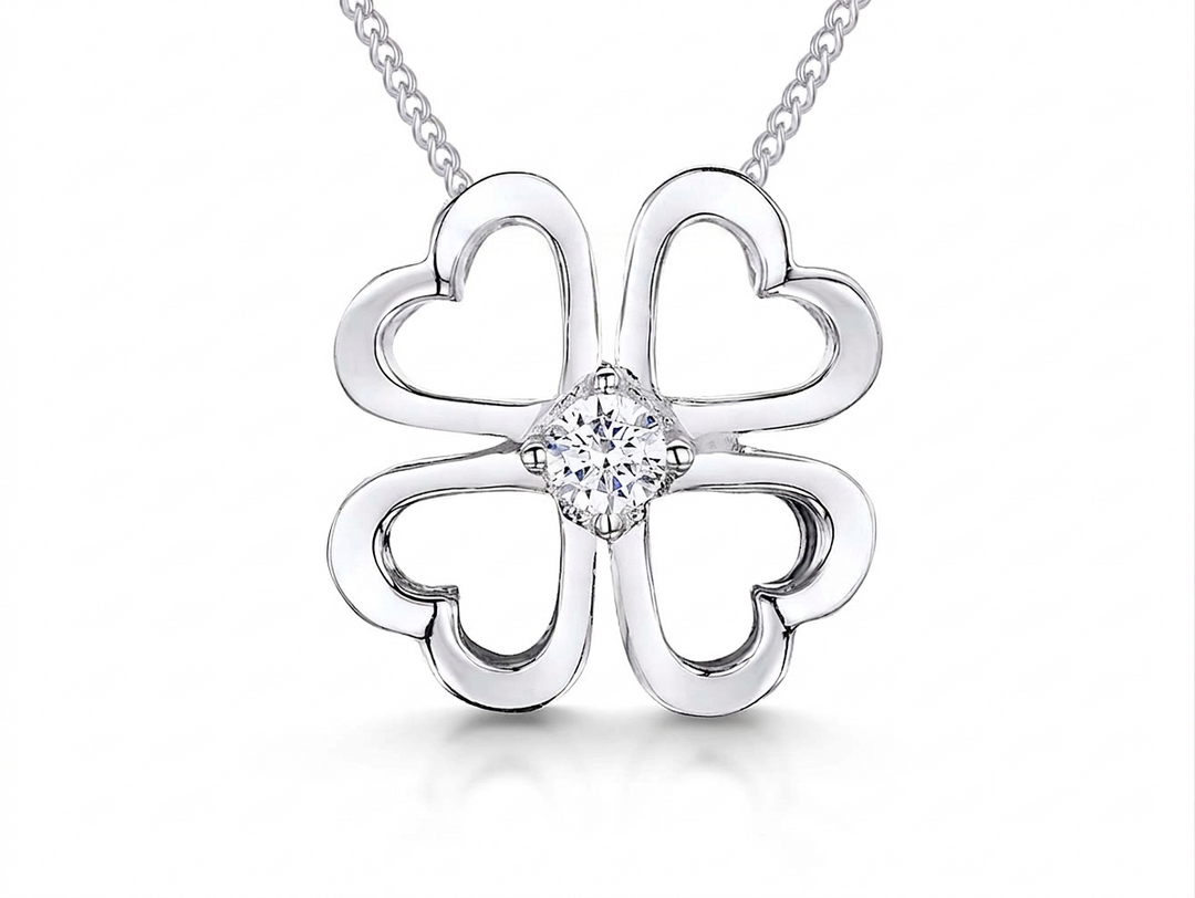 Sterling silver open four leaf clover pendant with a 3mm central cubic zirconia, attached to a silver chain-JOOLS by Jenny Brown